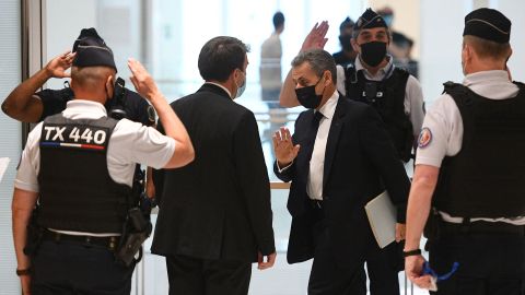 Former French President Nicolas Sarkozy (center) arrives at a hearing for the "Bygmalion case," in Paris in June. 