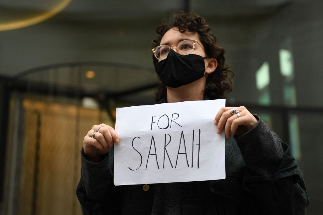 A woman holds a placard outside the London's Old Bailey court on Thursday.