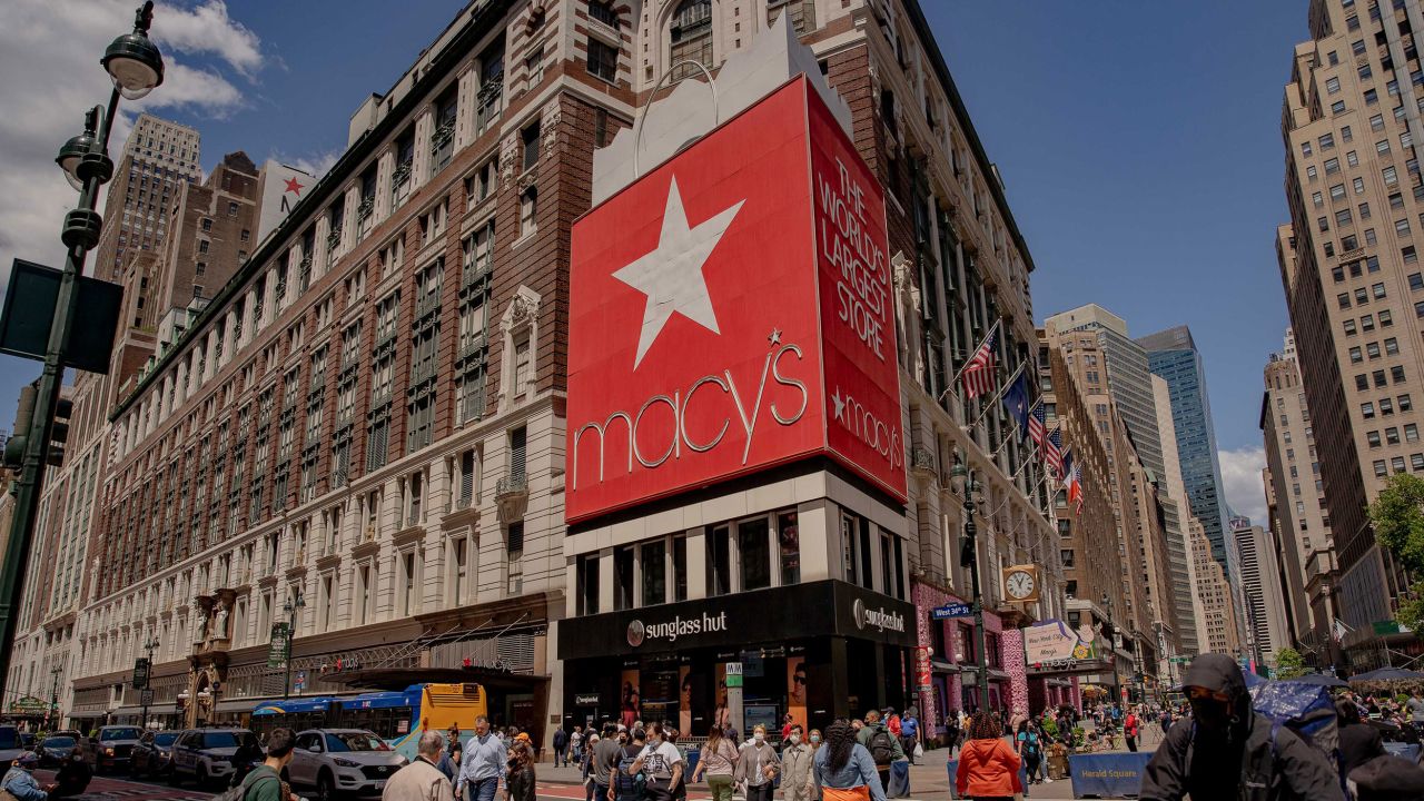 Pedestrians pass in front of Macy's Inc. flagship department store earlier this year. Macy's is suing to stop Amazon from advertising on this billboard.