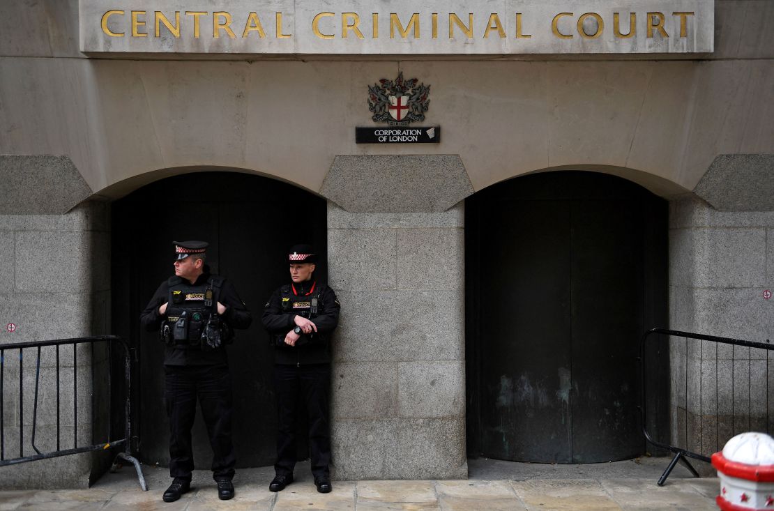 Police officers stand on duty outside the Old Bailey, England's central criminal court, as they await the sentencing of Wayne Couzens for the murder.