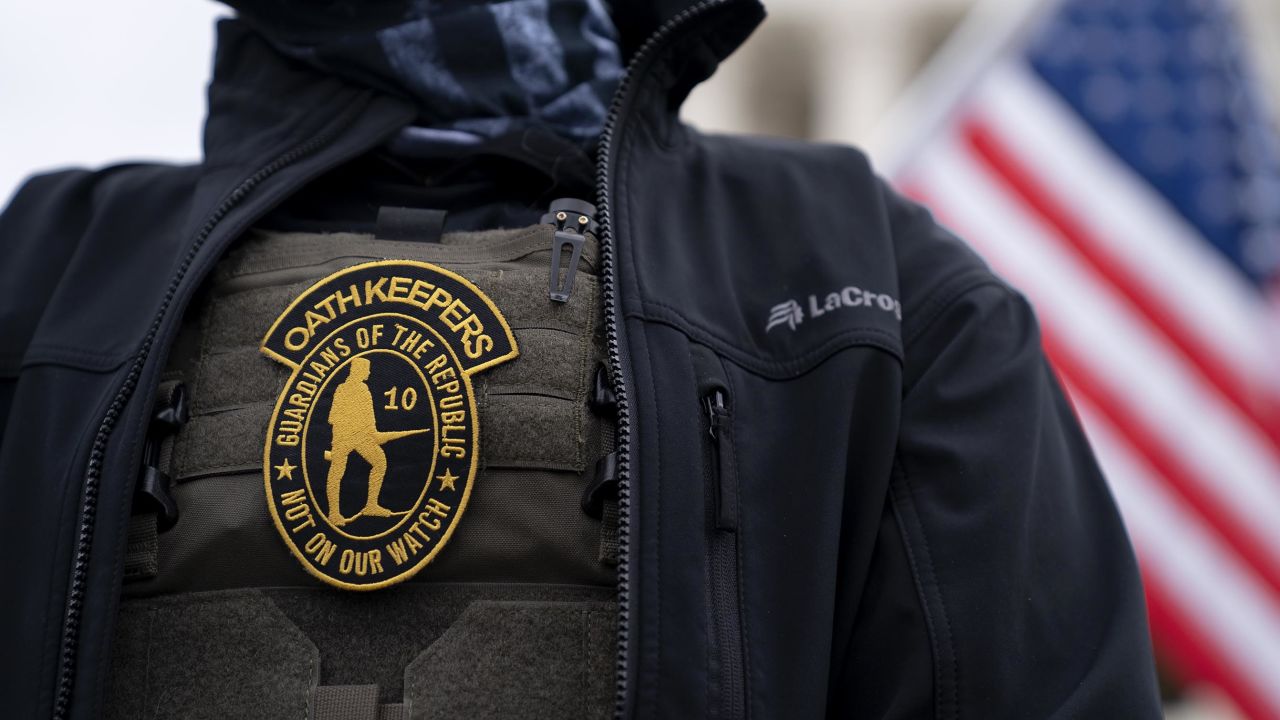 A demonstrator wears an Oath Keepers badge on a protective vest during a protest outside the Supreme Court in Washington, DC, on January  5, 2021. 