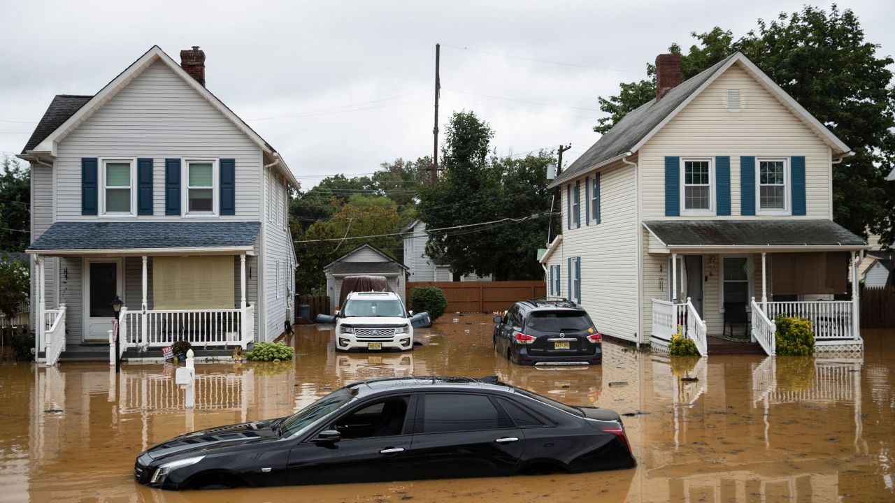 A submerged Cadillac sedan is seen on a residential street following a flash flood, as Tropical Storm Henri makes landfall, in Helmetta, New Jersey, on August 22, 2021. -