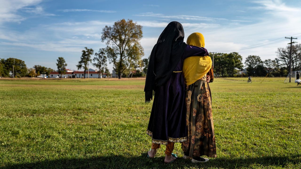 Afghan refugee girls watch a soccer match near where they are staying in the Village at the Ft. McCoy U.S. Army base on September 30, 2021 in Ft. McCoy, Wisconsin. 