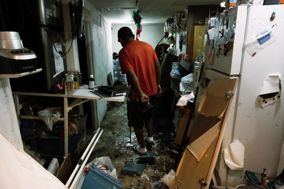 A Queens resident walks through his damaged basement-level apartment after flooding from the remnants of Hurricane Ida in September.