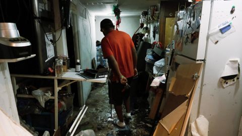 A Queens resident walks through his damaged basement-level apartment after flooding from the remnants of Hurricane Ida in September.