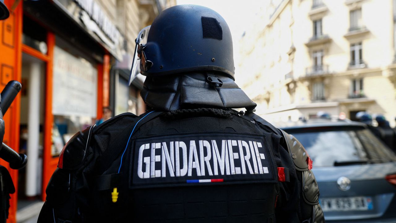 A French gendarme, or military police officer, stands during a demonstration against  the French government in Paris on July 24, 2021.