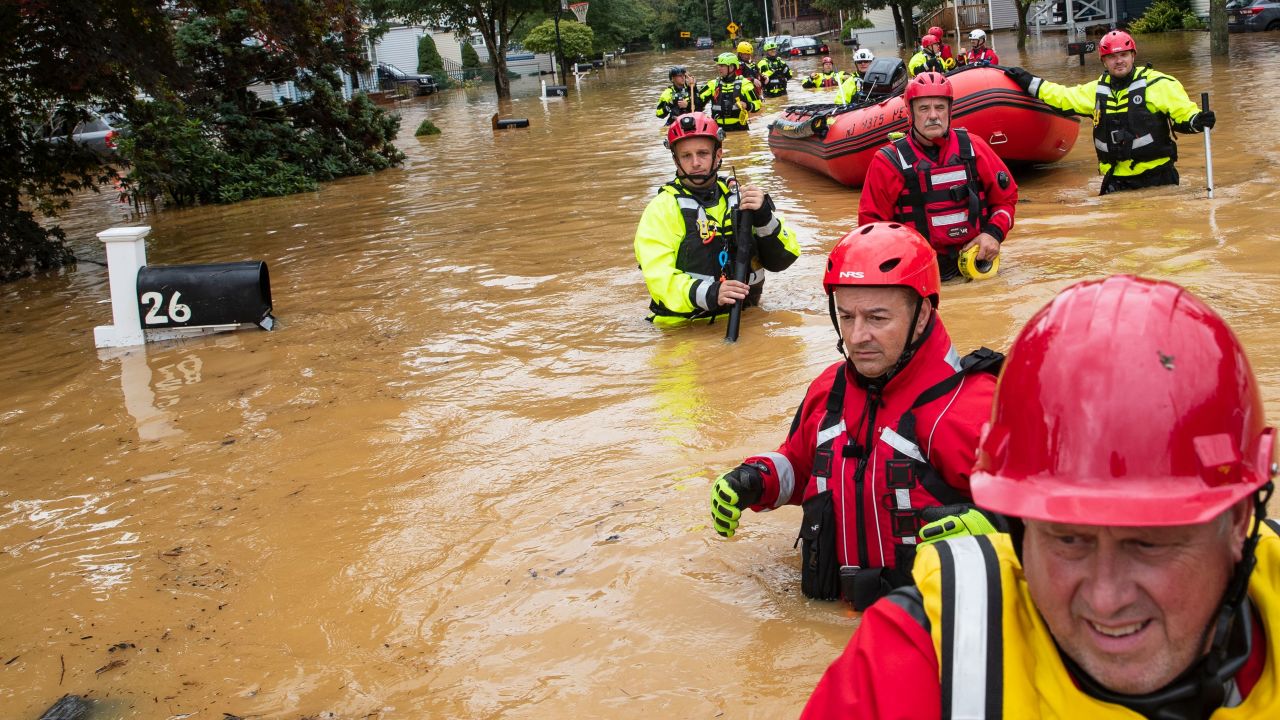 Members of the New Market Volunteer Fire Company perform a secondary search in Helmetta, New Jersey, during an evacuation effort following a flash flood from Tropical Storm Henri.