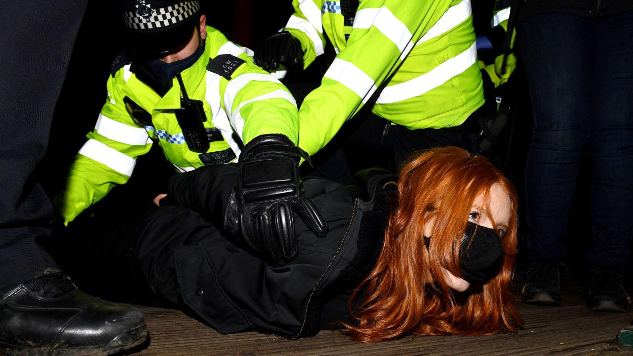 A woman attending the Sarah Everard vigil in south London on March 13, 2021 is arrested by police.  