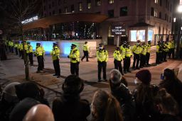 Police officers form a cordon at New Scotland Yard, the headquarters of the Metropolitan Police Service, in central London on March 14, 2021 as protesters call for greater public safety for women after the death of Sarah Everar.