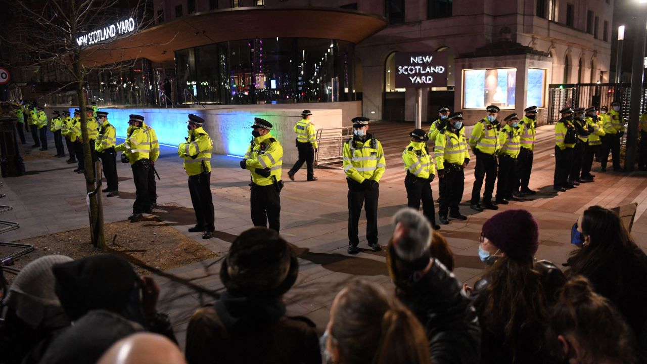 Police officers form a cordon at New Scotland Yard, the headquarters of the Metropolitan Police Service, in central London on March 14, 2021 as protesters called for greater public safety for women in the wake of Sarah Everard's murder. 