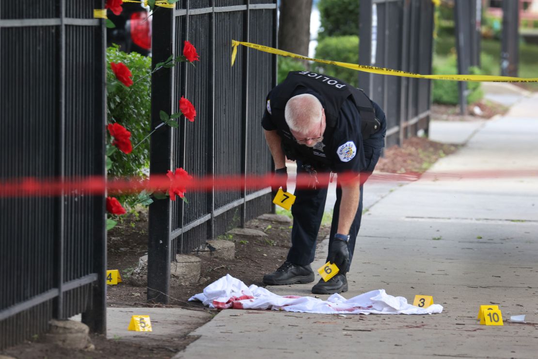 Police investigate a crime scene where three people were shot -- one fatally -- in the Bridgeport neighborhood on June 23, 2021, in Chicago. The city has recorded 756 homicides so far this year.