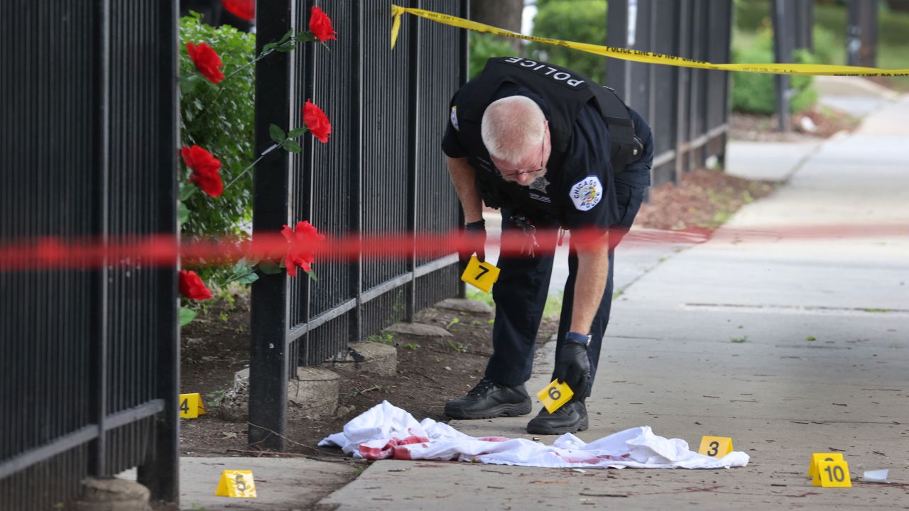 Police investigate a crime scene where three people were shot -- one fatally -- in the Bridgeport neighborhood on June 23, 2021, in Chicago.