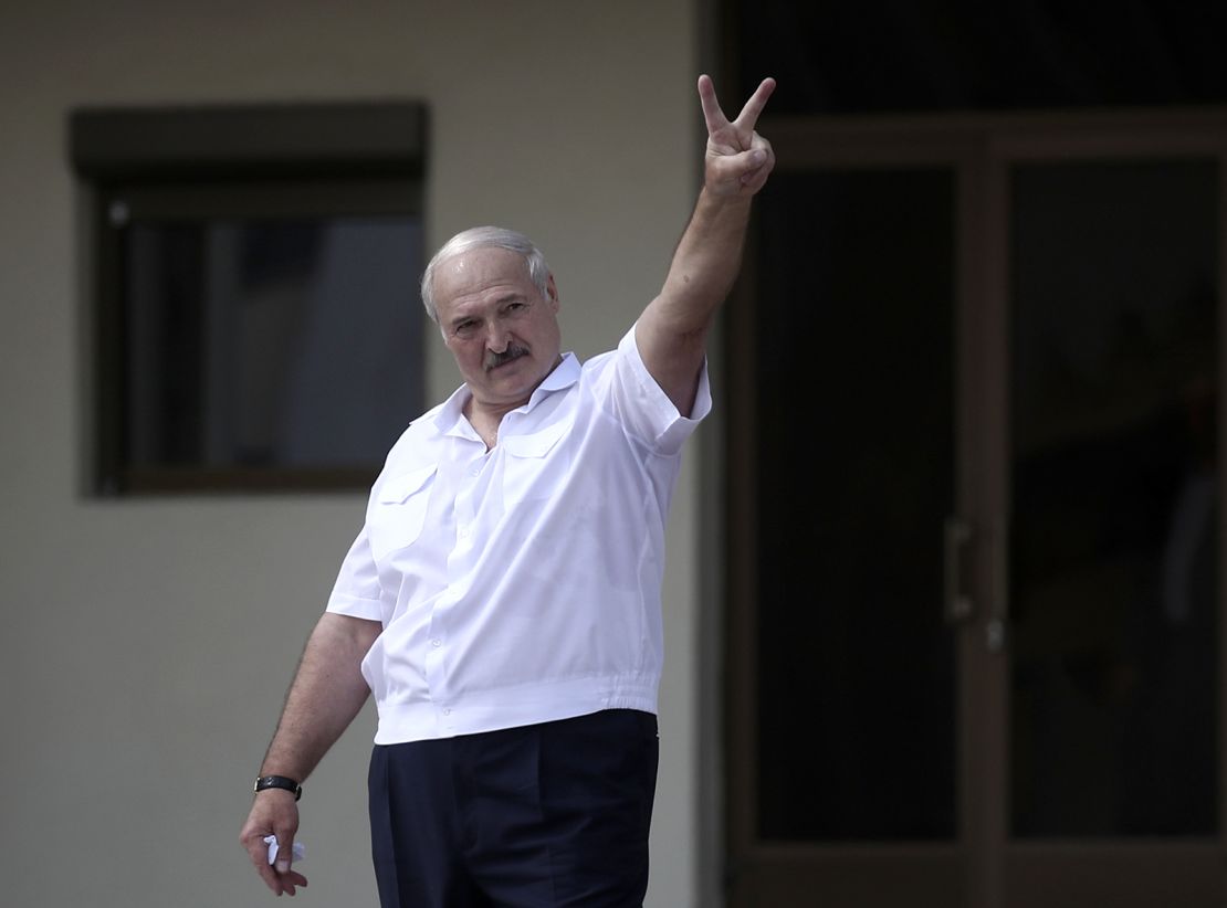 Lukashenko makes a victory sign for his supporters after the disputed 2020 election.