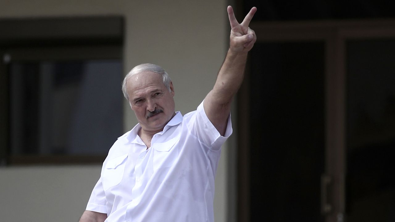 Lukashenko makes a victory sign for his supporters after the disputed 2020 election.