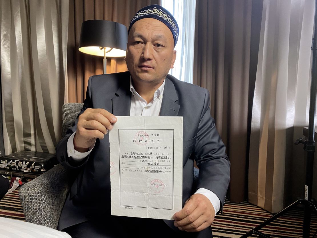 Omir Bekali holds his official form stating he was released from detention on bail in November 2018, pending trial.