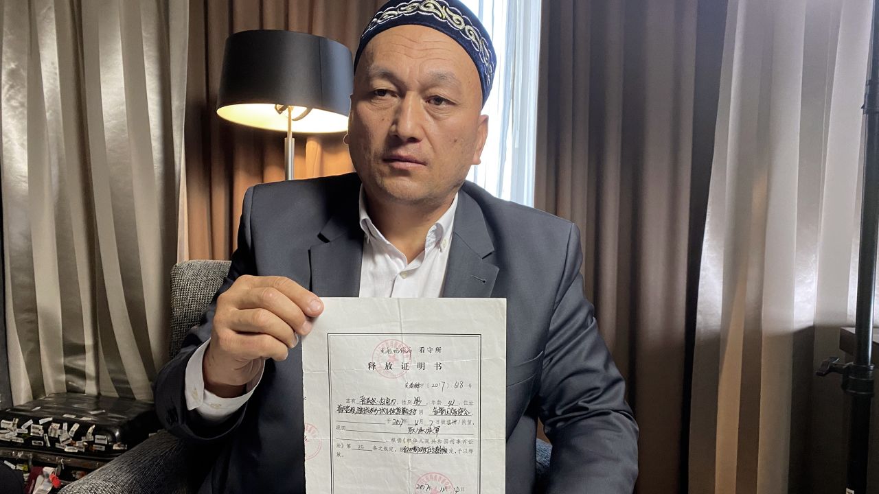 Omir Bekali holds his official form stating he was released from detention on bail in November 2018, pending trial.