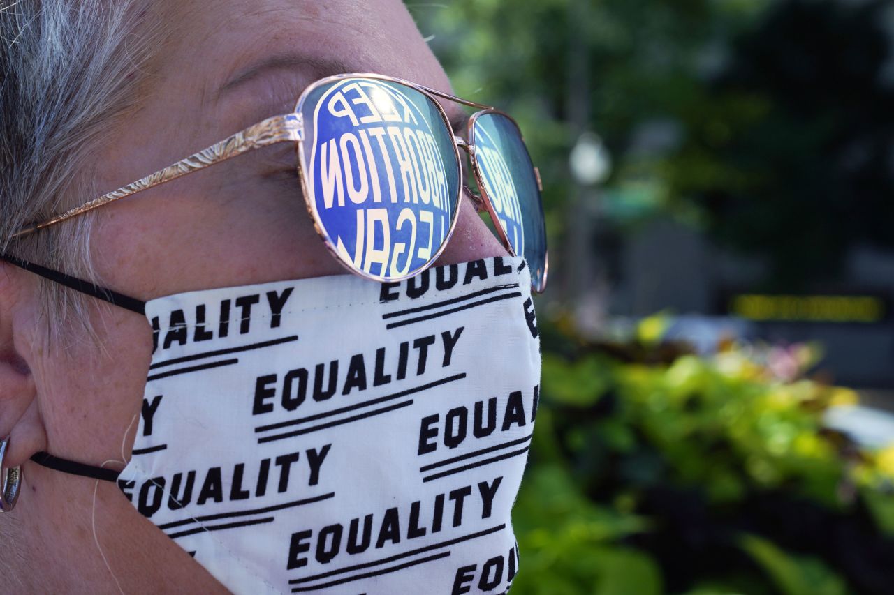 A sign advocating for legal abortion is reflected in a protester's eyeglasses in Washington, DC.