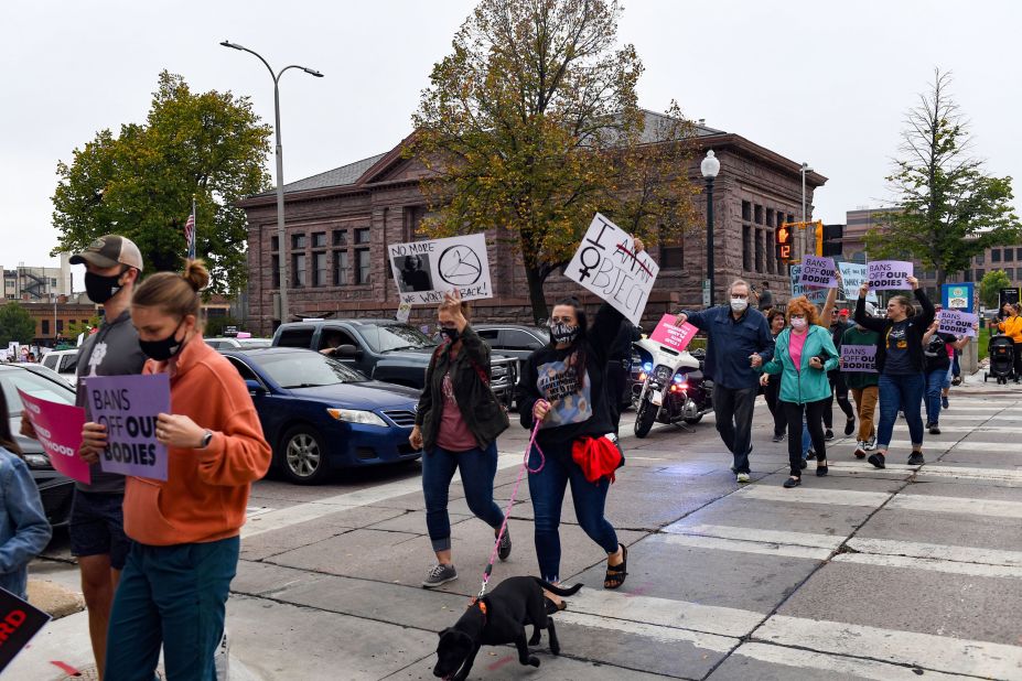 Traffic makes way for protesters walking from Carnegie Hall to the Minnehaha County Courthouse in Sioux Falls, South Dakota.
