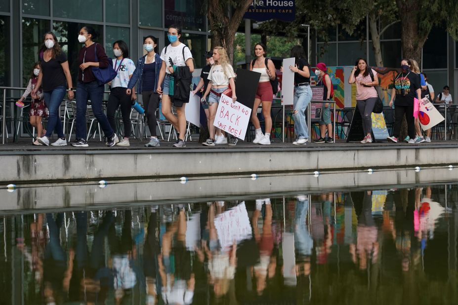 March participants in Houston carry signs.