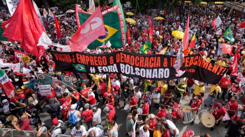 Demonstrators rally alongside a banner with a message that reads in Portuguese: "vaccine and jobs, democracy and impeachment, Bolsonaro get out", during a protest against Brazilian President Jair Bolsonaro in Sao Paulo, Brazil, on October 2.
