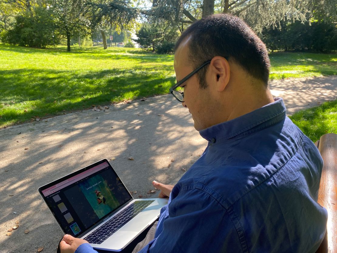 Abduweli Ayup looks at one of the children's book written in Uyghur that he uses to keep the language alive.