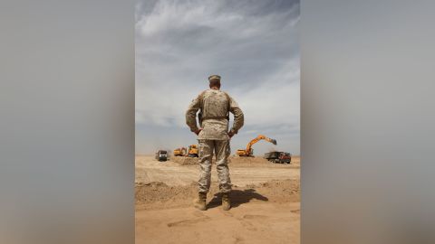 US Marine MSgt. Charles Albrecht watches a construction crew working on a massive new base at Camp Letherneck, Helmand province, in March 2009.