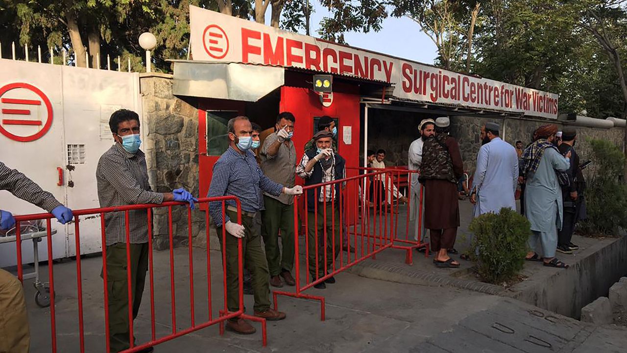 Afghan medical staff members stand at the entrance of a hospital as they wait to receive the victims of an explosion in Kabul on October 3, 2021. (Photo by Hoshang HASHIMI / AFP) (Photo by HOSHANG HASHIMI/AFP via Getty Images)