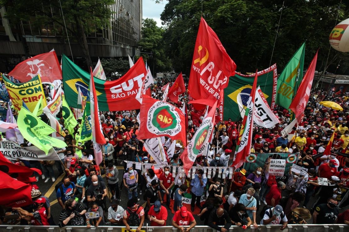 Demonstrators wave banners and flags against Brazilian President Jair Bolsonaro during a protest against his government on October 2, 2021 in Sao Paulo, Brazil.