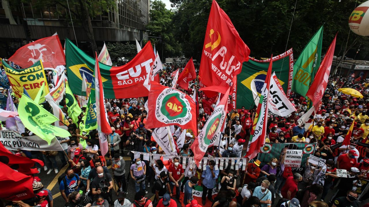 Demonstrators wave banners and flags against Brazilian President Jair Bolsonaro during a protest against his government on October 2, 2021 in Sao Paulo, Brazil.