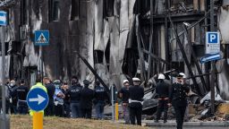 SAN DONATO MILANESE, ITALY - OCTOBER 03: Firefighters and police forces stand next to the impact point as a small private plane, which took off from the nearby Milan Linate airport heading to Sardinia, crashed on a building under renovation near the San Donato Metro Station on October 03, 2021 in San Donato Milanese, near Milan, Italy. (Photo by Emanuele Cremaschi/Getty Images)