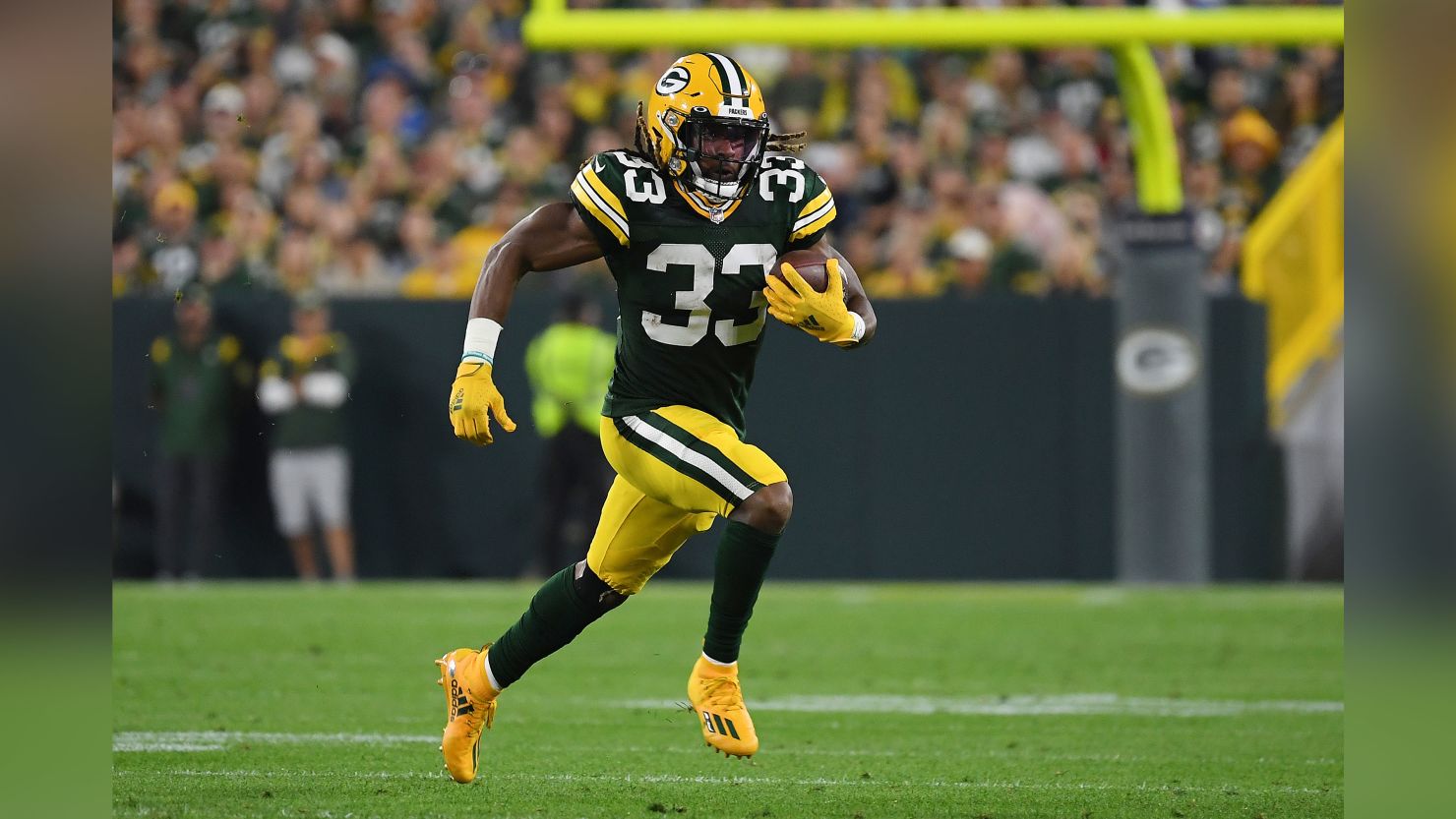 Aaron Jones #33 of the Green Bay Packers runs against the Detroit Lions during the first half at Lambeau Field on September 20, 2021 in Green Bay, Wisconsin. 