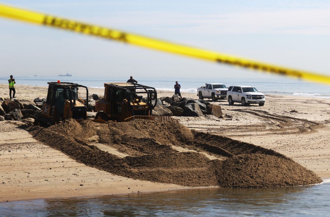 A cleanup crew works near Huntington State Beach in California.