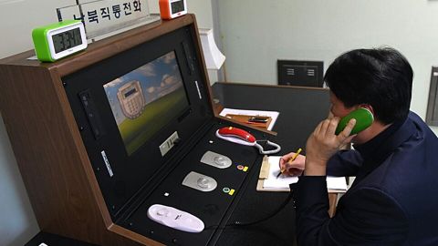 A South Korean government official communicates with a North Korean officer on the dedicated communications hotline at the border village of Panmunjom, South Korea, on January 3, 2018.