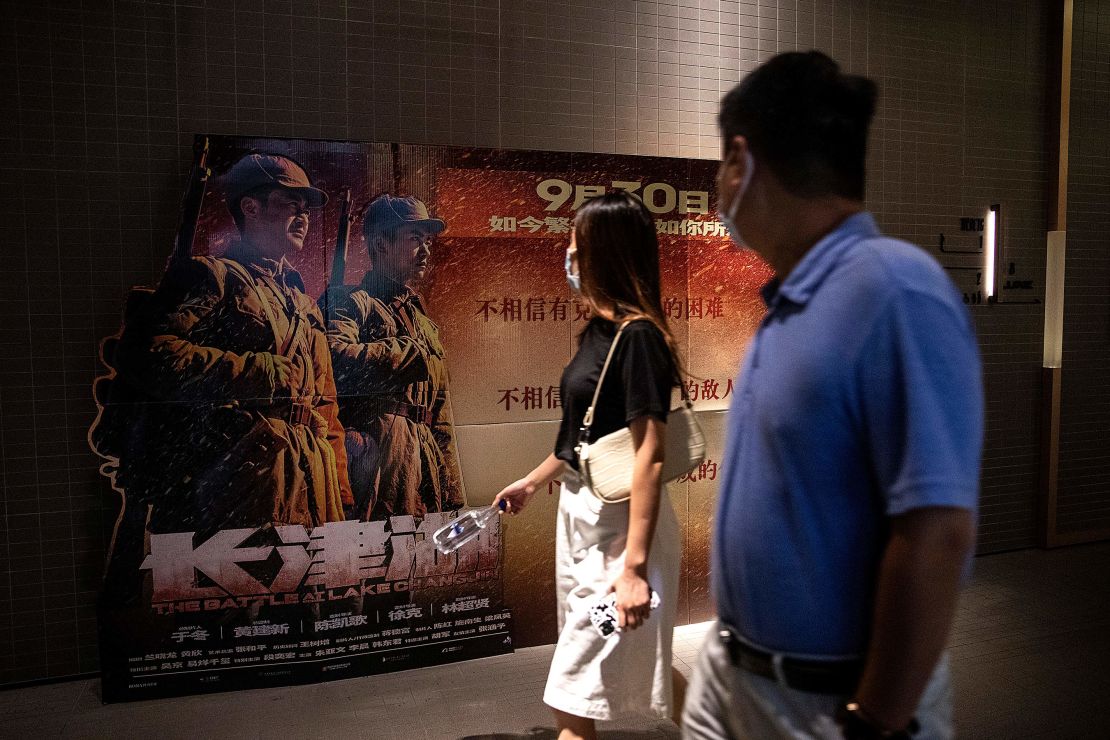 Movie goers passing in front of a poster for "The Battle At Lake Changjin" in a cinema in Wuhan, China. 