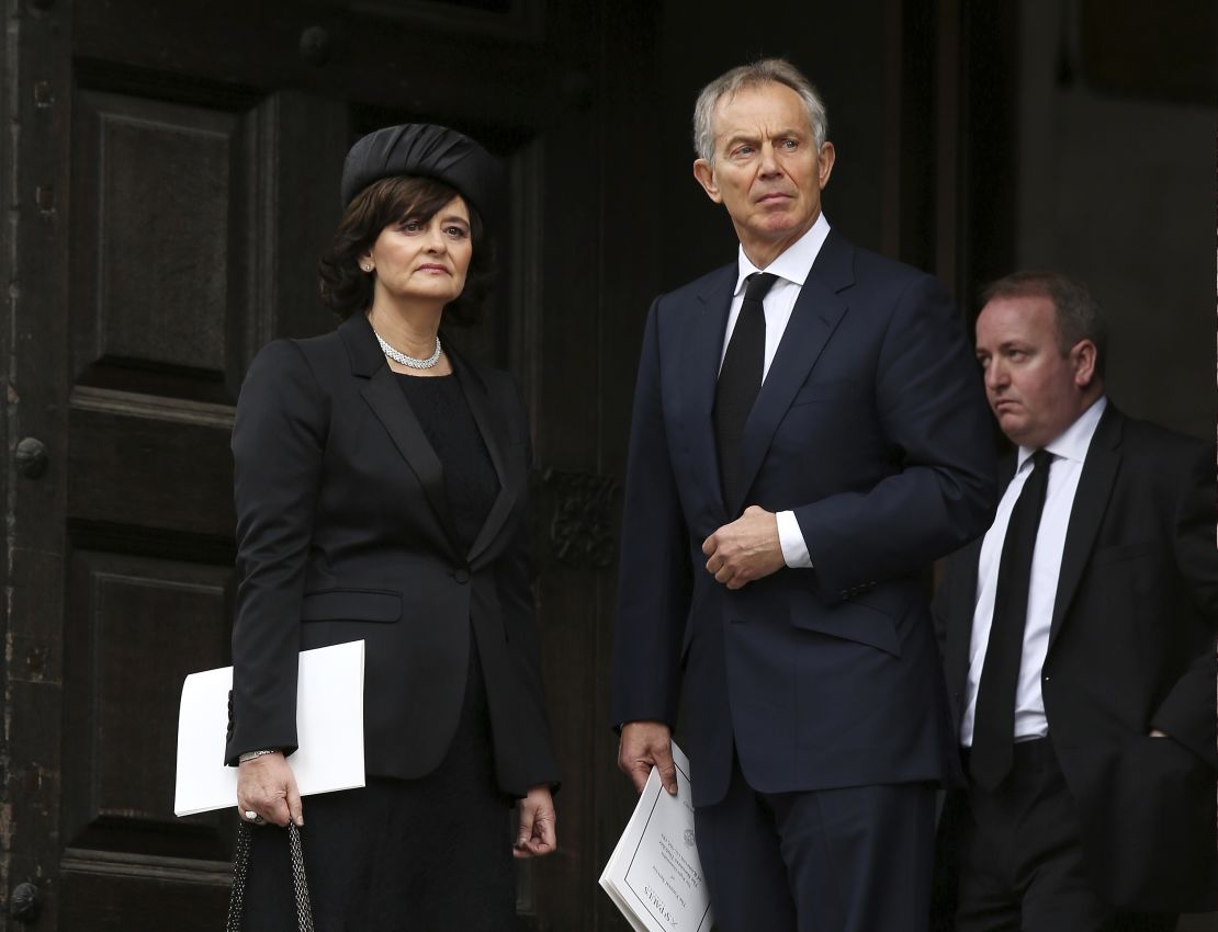 Former British Prime Minister Tony Blair and his wife Cherie Blair leave a funeral on April 17, 2013. 