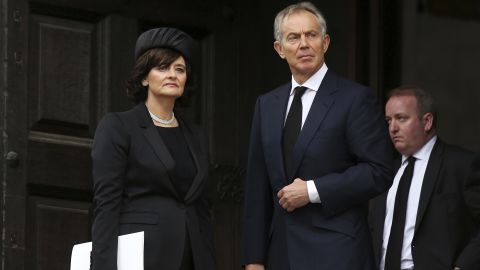 Former British Prime Minister Tony Blair and his wife Cherie Blair leave a funeral on April 17, 2013.