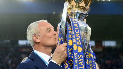 Ranieri kisses the Premier League trophy after winning the competition.