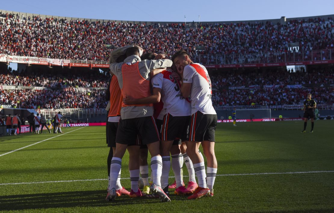 River Plate players celebrate in front of a packed stand.