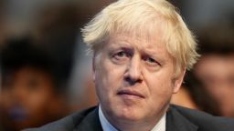 British Prime Minister Boris Johnson listens to Chancellor of the Exchequer Rishi Sunak delivering his speech on day two of the Conservative Party Conference at Manchester Central Convention Complex on October 4, 2021 in Manchester, England. 