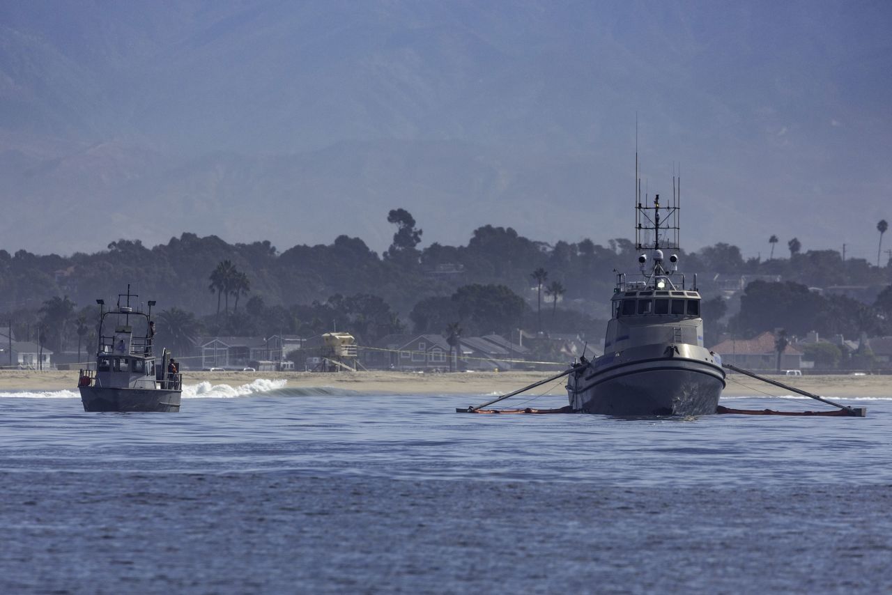 Oil-skimming boats work the waters off the coast of Huntington Beach on October 3.