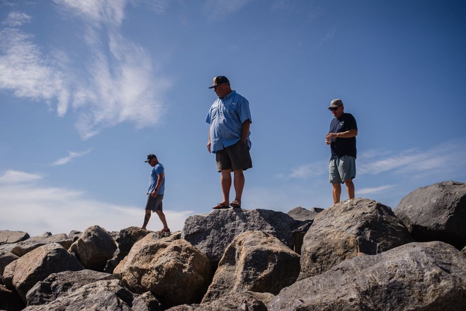 Local residents look for signs of damage in Huntington Beach.