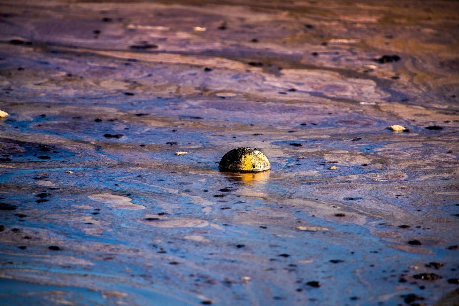 A ball floats in oil that had washed ashore on October 3.