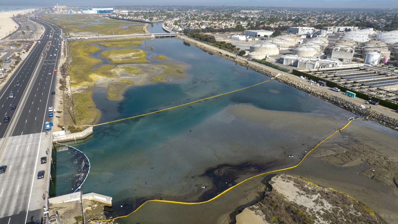 Booms float in the Talbert Marsh in Huntington Beach, California, as workers try to limit the spread of oil from an offshore spill.