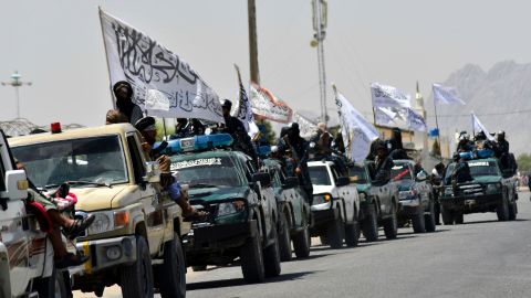 Taliban fighters atop vehicles with Taliban flags parade along a road to celebrate after the US pulled all its troops out of Afghanistan, in Kandahar on September 1.
