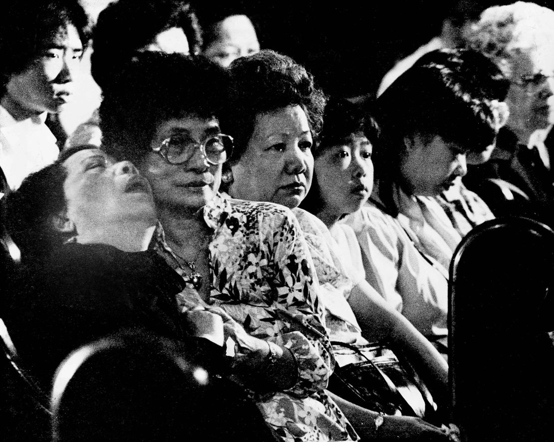 Lily Chin, left, is comforted during a memorial service for her son, Vincent.