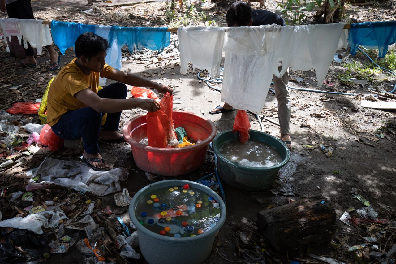 Activists working with the museum help wash plastic waste for the exhibition.