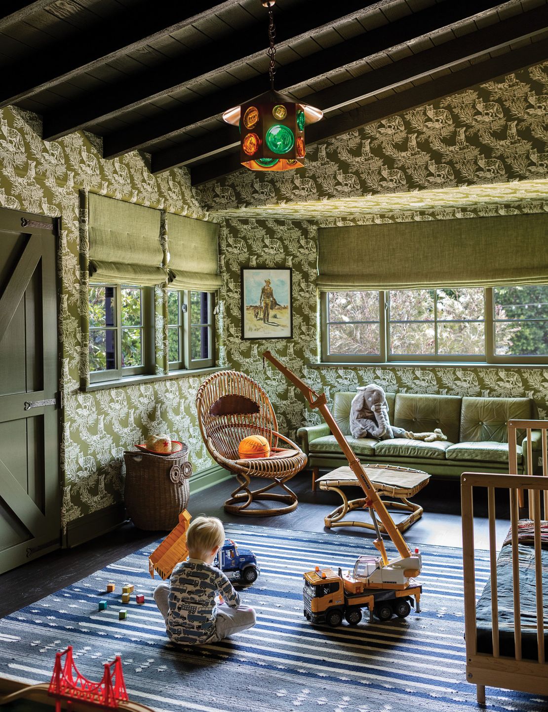A plush, velvet couch adds comfort to Dunst's verdant nursery.