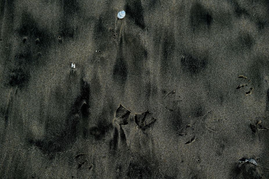 Oil residue mixed with sand covers part of the Bolsa Chica State Beach on October 4.