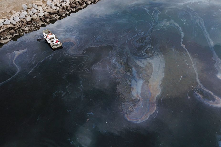 This aerial photo, taken on October 4, shows environmental response crews cleaning up oil that flowed near the Talbert Marsh in Huntington Beach.
