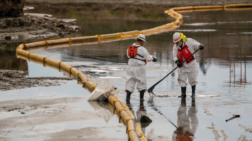Patriot Environmental employees work to clear oil from the surface of the water inside Talbert Marsh, in the affected area of the oil spill off the coast of Huntington Beach, California on Monday, October 4, 2021. California is now facing a possible ecological disaster after 126,000 gallons of oil spilled out of a pipeline off the coast of Huntington Beach in Orange County.